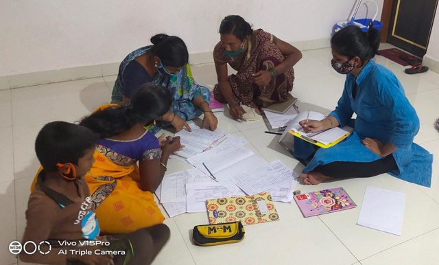 Sakhi program session with women seated outdoors