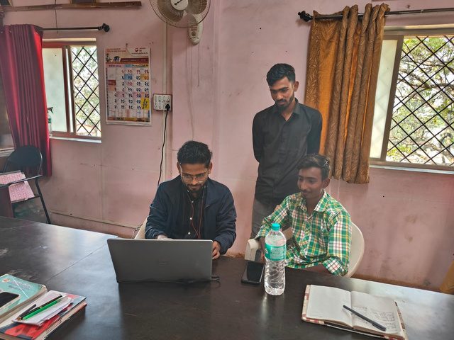 SikshaSetu mentors guiding students on a laptop
